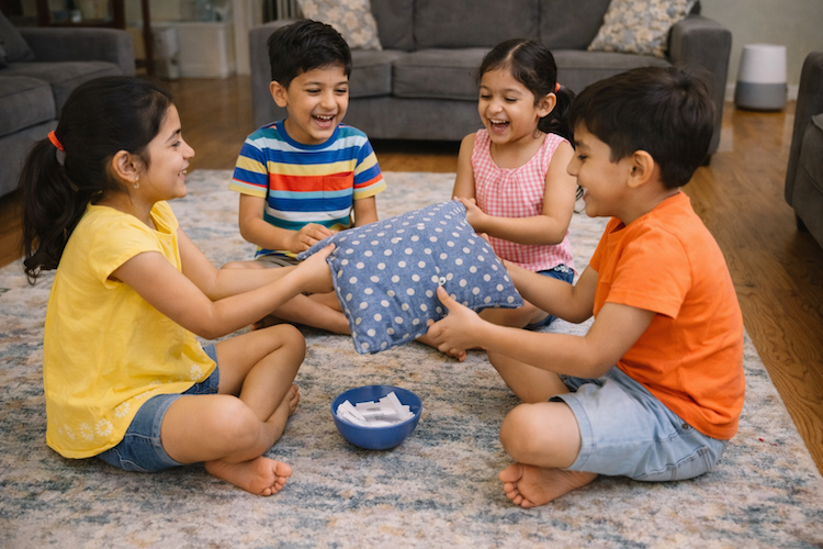 Children playing Hot Potato in living room
