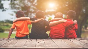 group-kids-friends-arm-around-sitting-together (1)