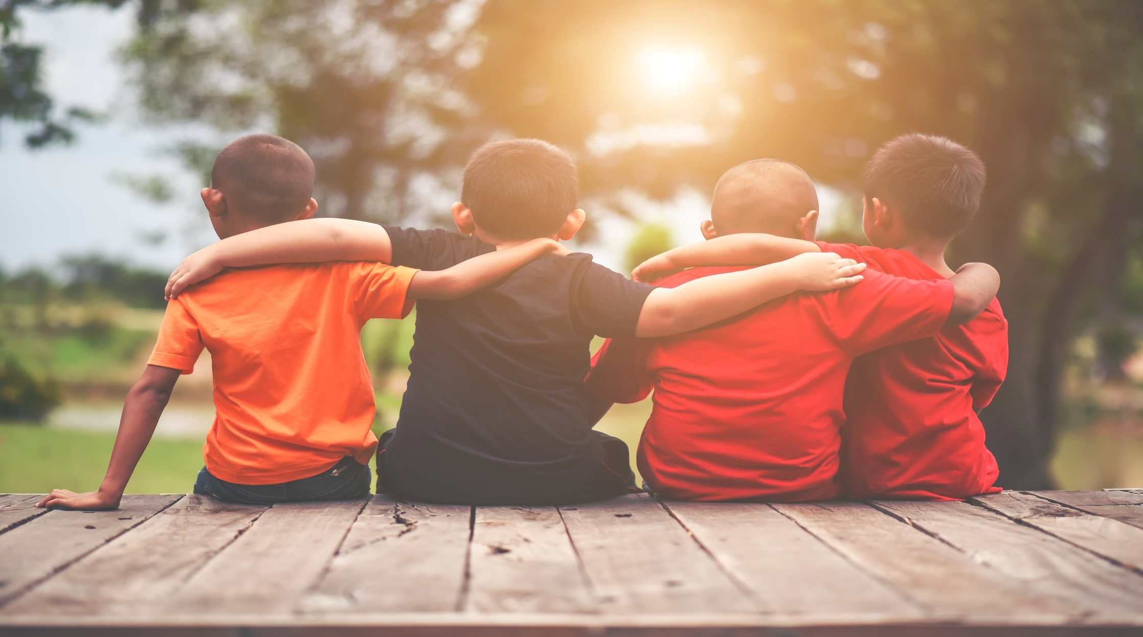 group-kids-friends-arm-around-sitting-together (1)