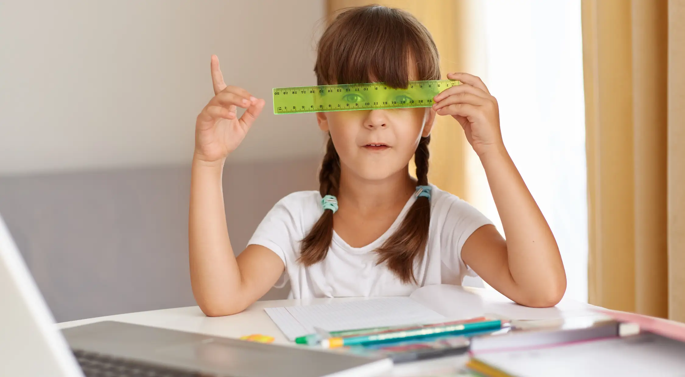 Girl engaging in focused study with a ruler in hand