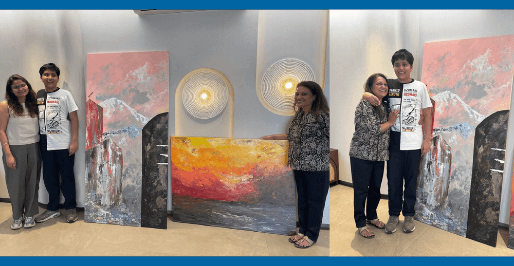 Jay with his mother and two paintings in background, purchased by the client. 