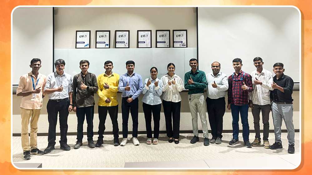 New employees showing a thumbs up at Emcure.
