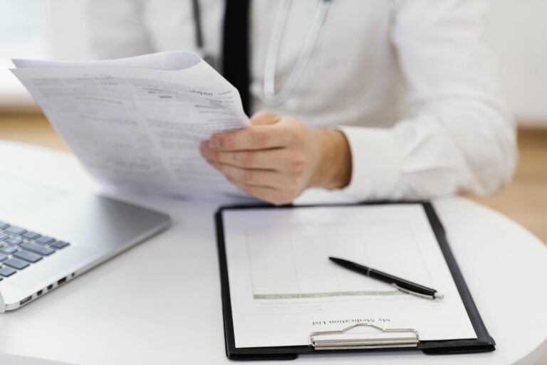 close-up-doctor-holding-medical-records.jpg