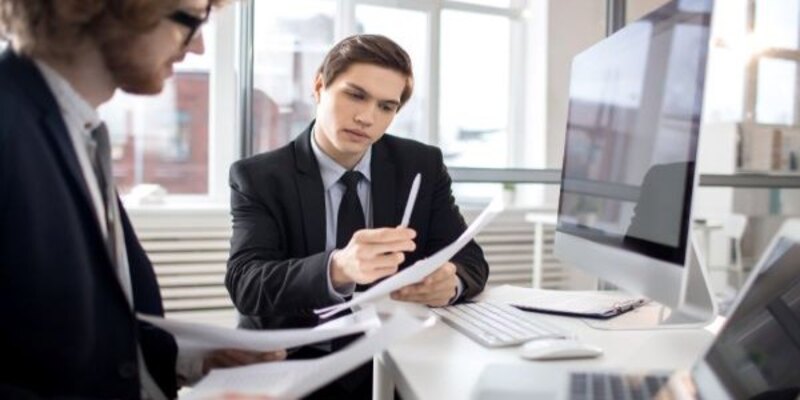 two persons looking at the documents