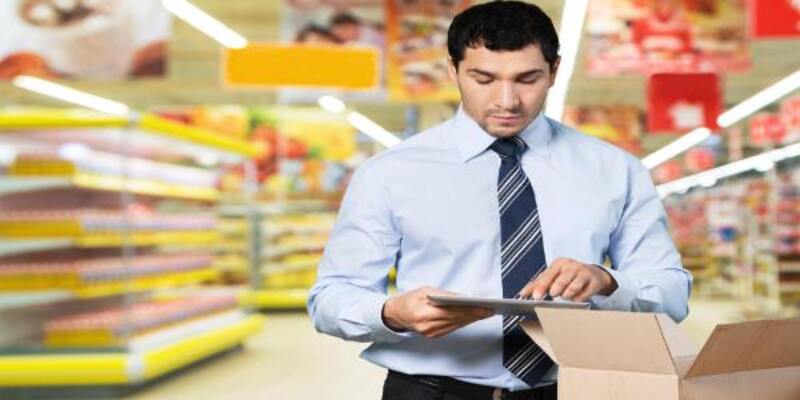 A person in warehouse using a digital tablet