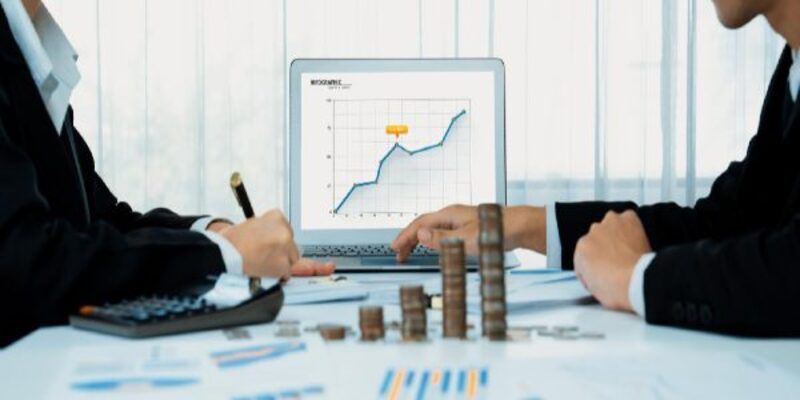 Business intelligence analyst use bi software on laptop with stack coin shrewd