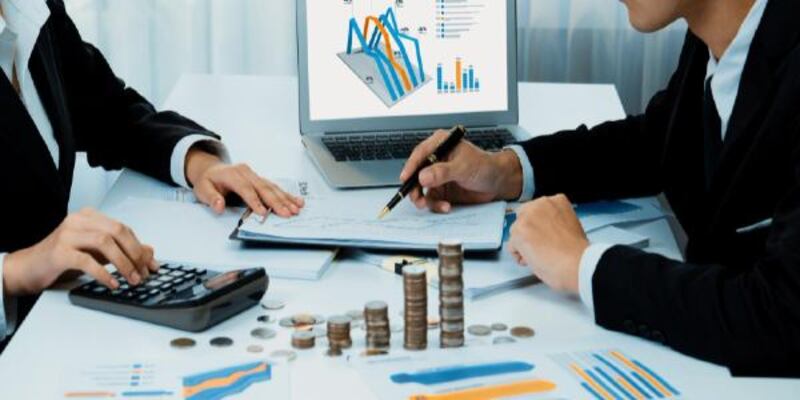 Business intelligence analyst use bi software on laptop with stack coin shrewd