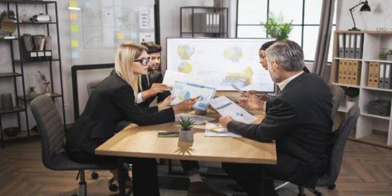 Female woman showing infographics and financial charts during meeting
