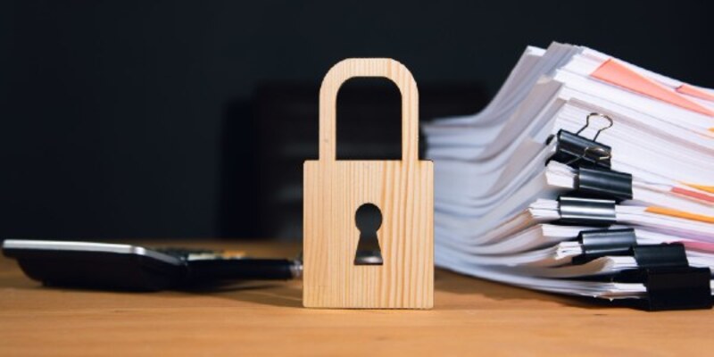 Real estate concept, stack of documents and house model