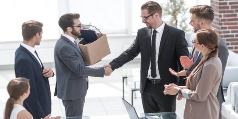 Handshake manager with employee in office business