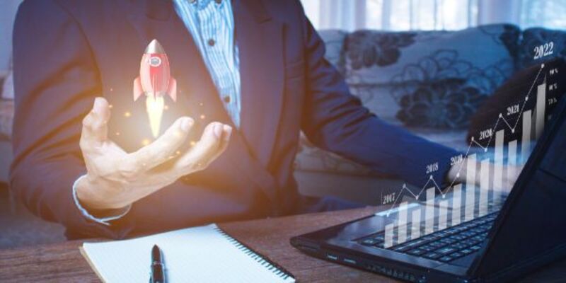 Businessman holding and showing a growing virtual hologram of statistics graph