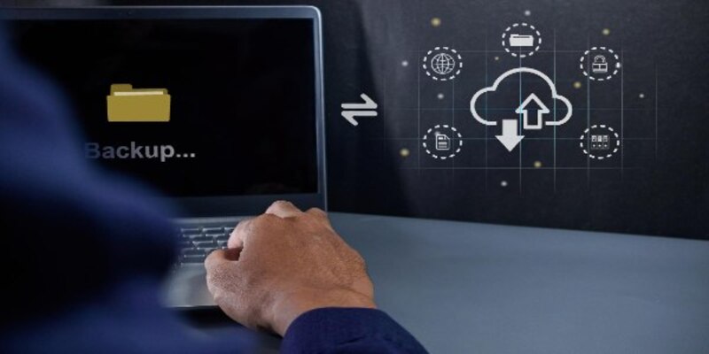 Businessman using a laptop to upload data to cloud storage data backup and cloud data storage