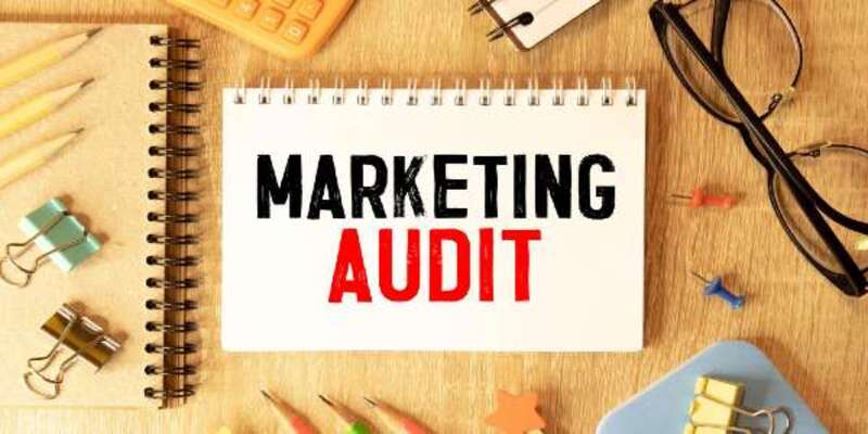 Business and industry concept a pen and sheet of paper with text marketing audit