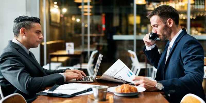 Businessmen cafe working newspaper concept