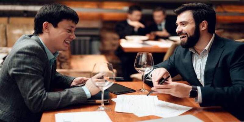 Man is showing his phone in a restaurant