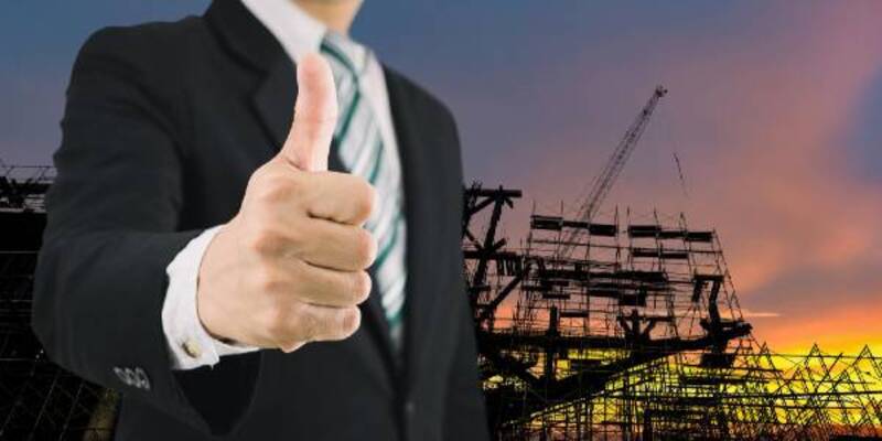 Businessman thumbs up industrial technology and construction