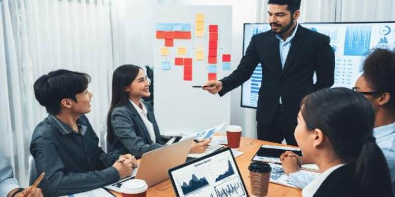 Businessman presenting data analysis dashboard on tv at meeting room