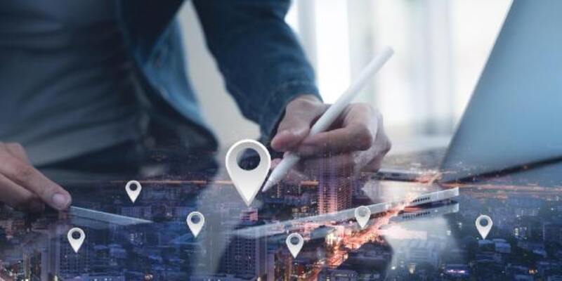 Gps map pin address locations man hand using digital tablet searching target place on night cityscape