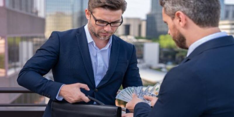 Businessmen giving money businessman offering money for business