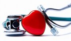 A close-up photo of a stethoscope and a stylized heart