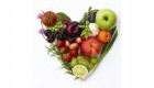 Healthy fruits and vegetables arranged in the shape of a stylized heart.