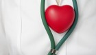 Doctor with red heart positioned within their stethoscope.