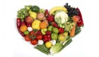 Vegetables and fruits arranged in the shape of a stylized heart