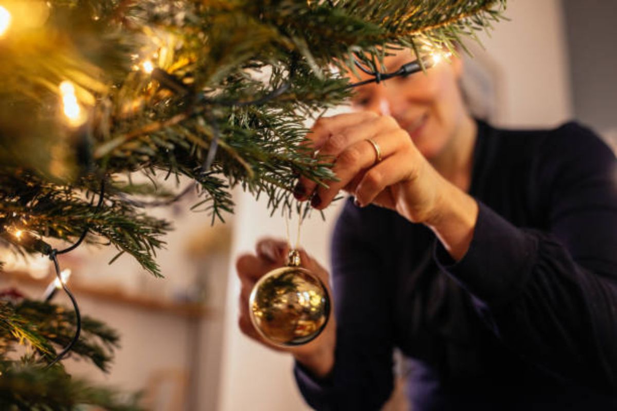 Hang Christmas Balls On Christmas Tree