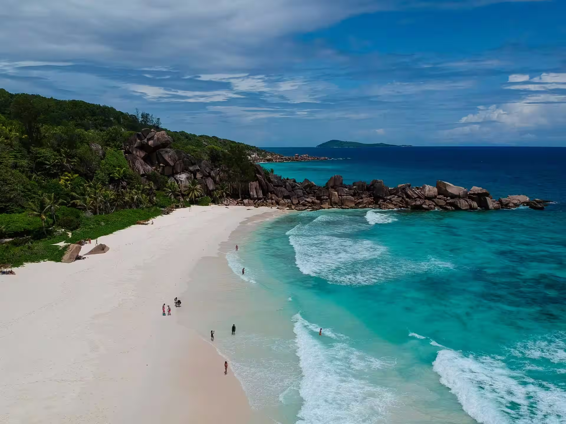 Sandy beach with calm waters at Anse Kerlan
