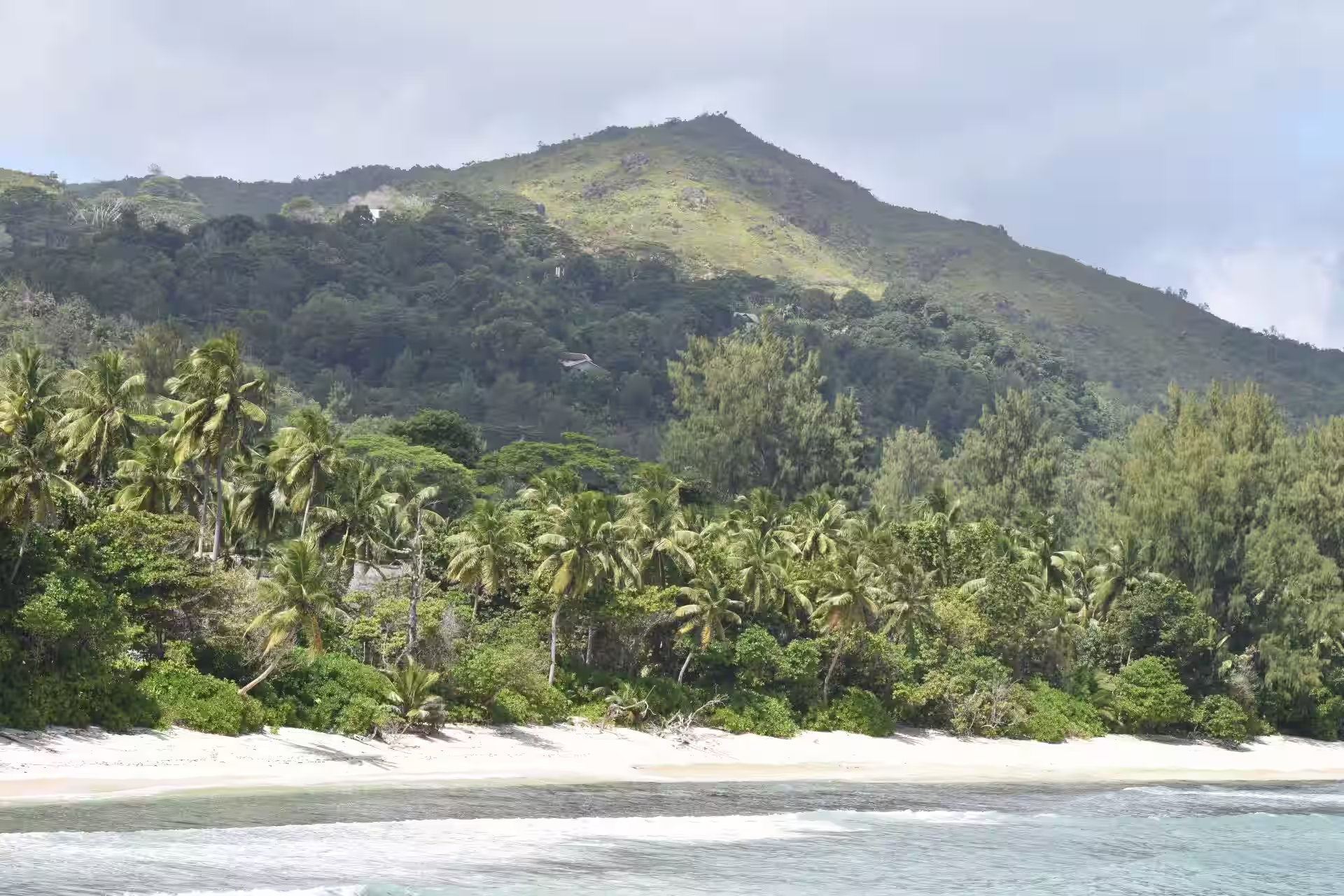 Sunny coastline showing best season to visit Mahé Island