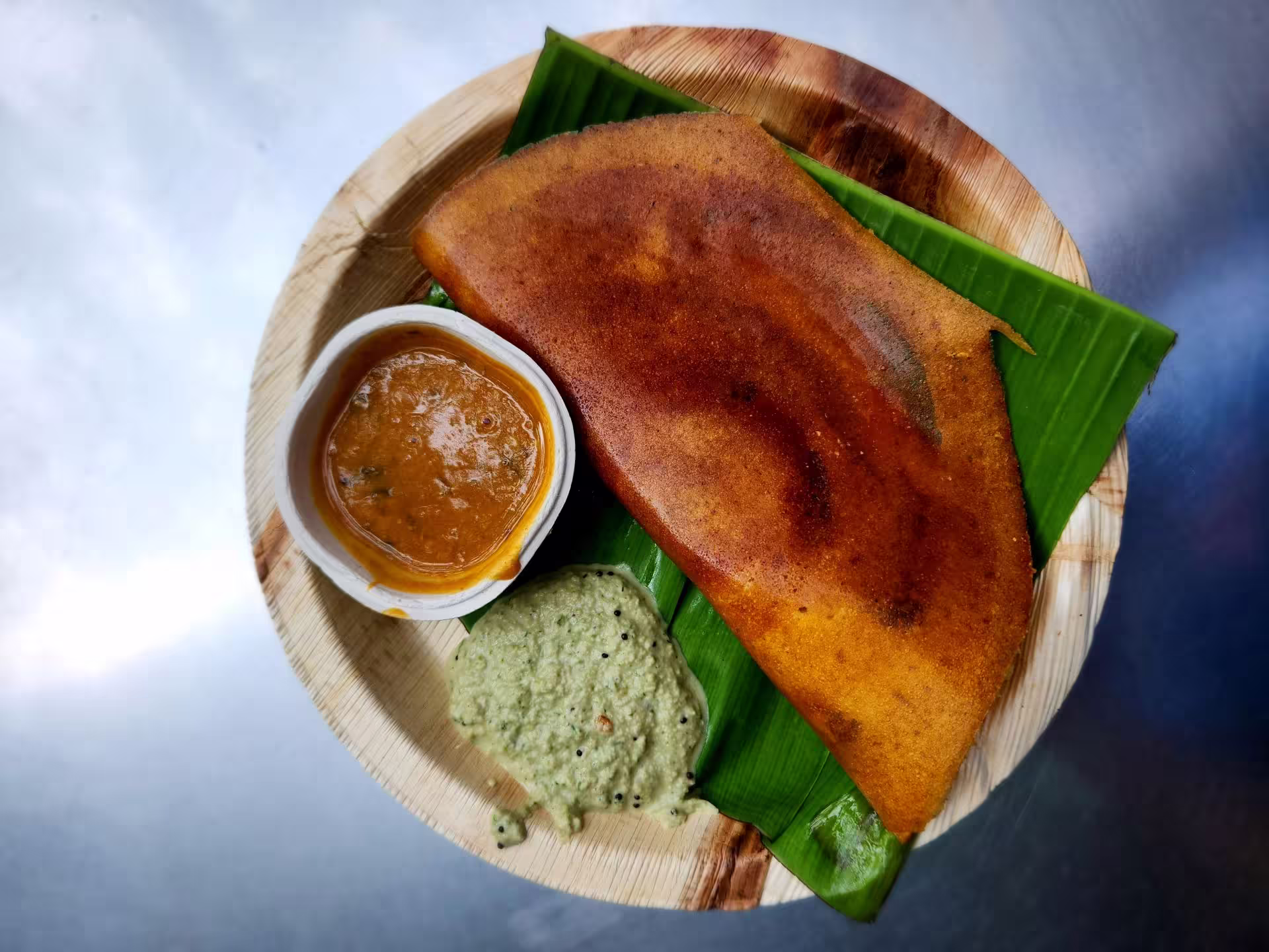 Traditional dosa served on banana leaf in Tamil Nadu