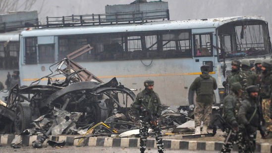 Security personnel stand guard hours after a suicide bomber rammed an explosives-laden car into a CRPF bus on the Jammu-Srinagar highway. (HT Photo)