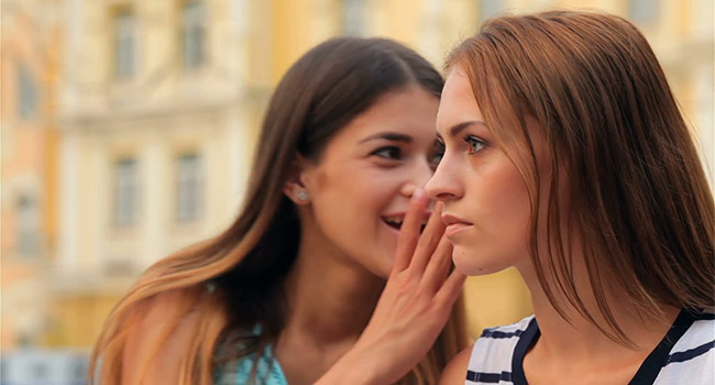 Girl whispering to her best friend