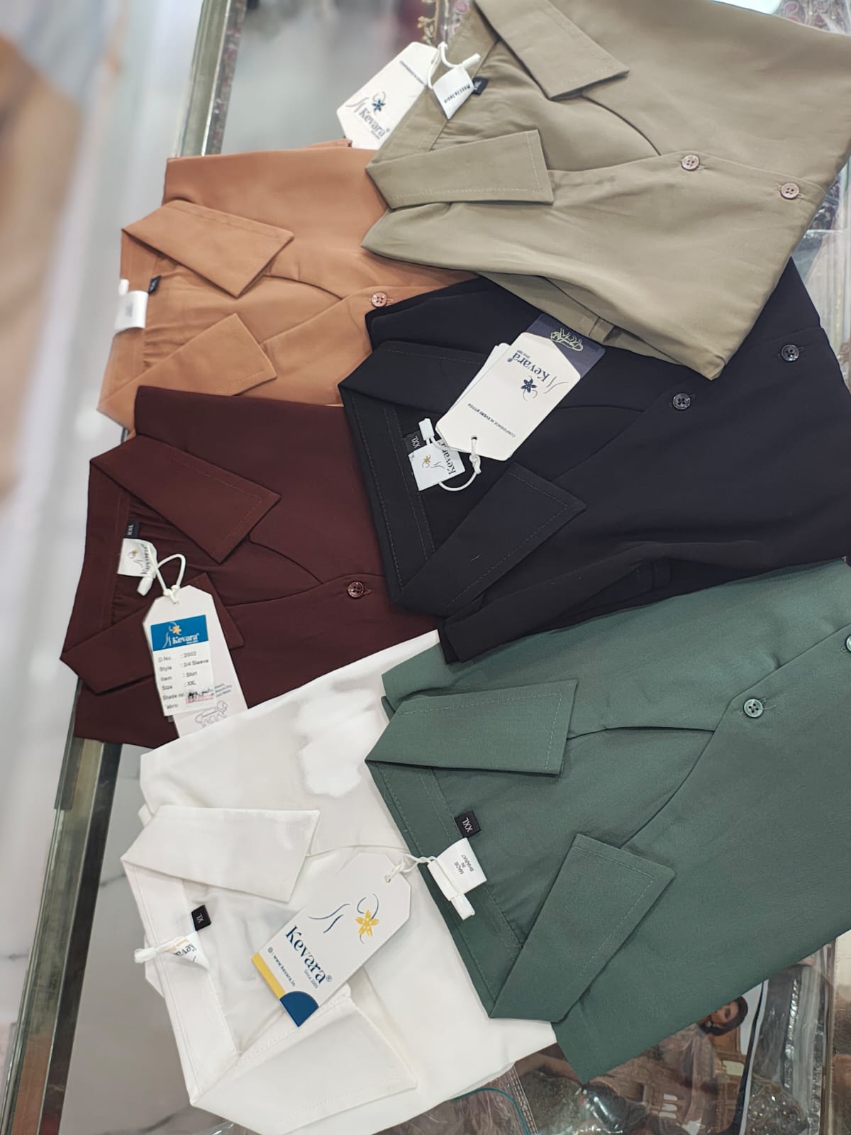 displays a catalog collage featuring a women's casual button-down shirt available in multiple color options.