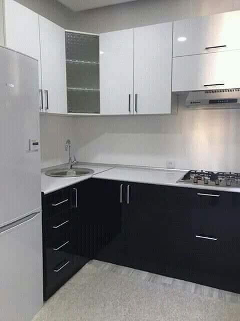 Kitchen Wardrobe Design with White Countertops & Black Cabinets