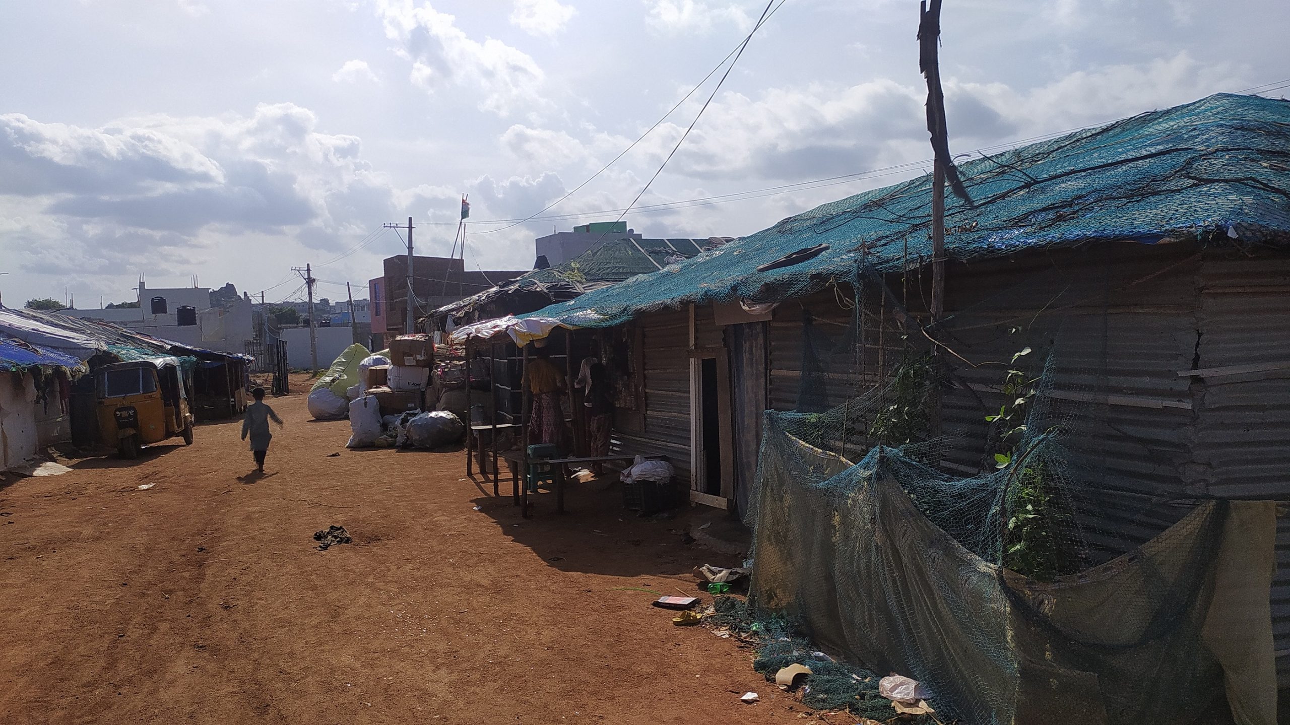 Neighbourhood buildings behind the camp. (deeksha Devadiga/South First)