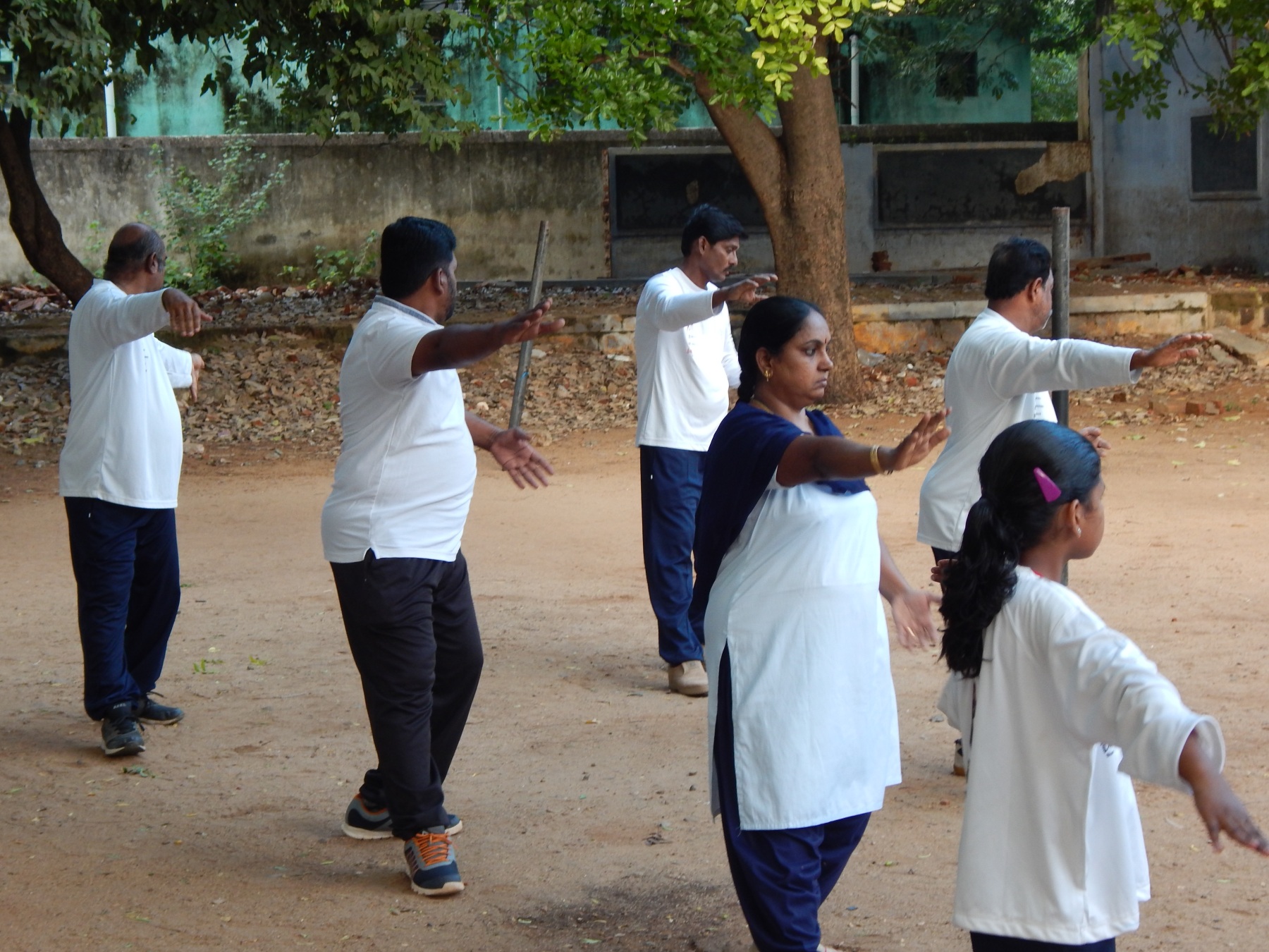 People practise tai chi.