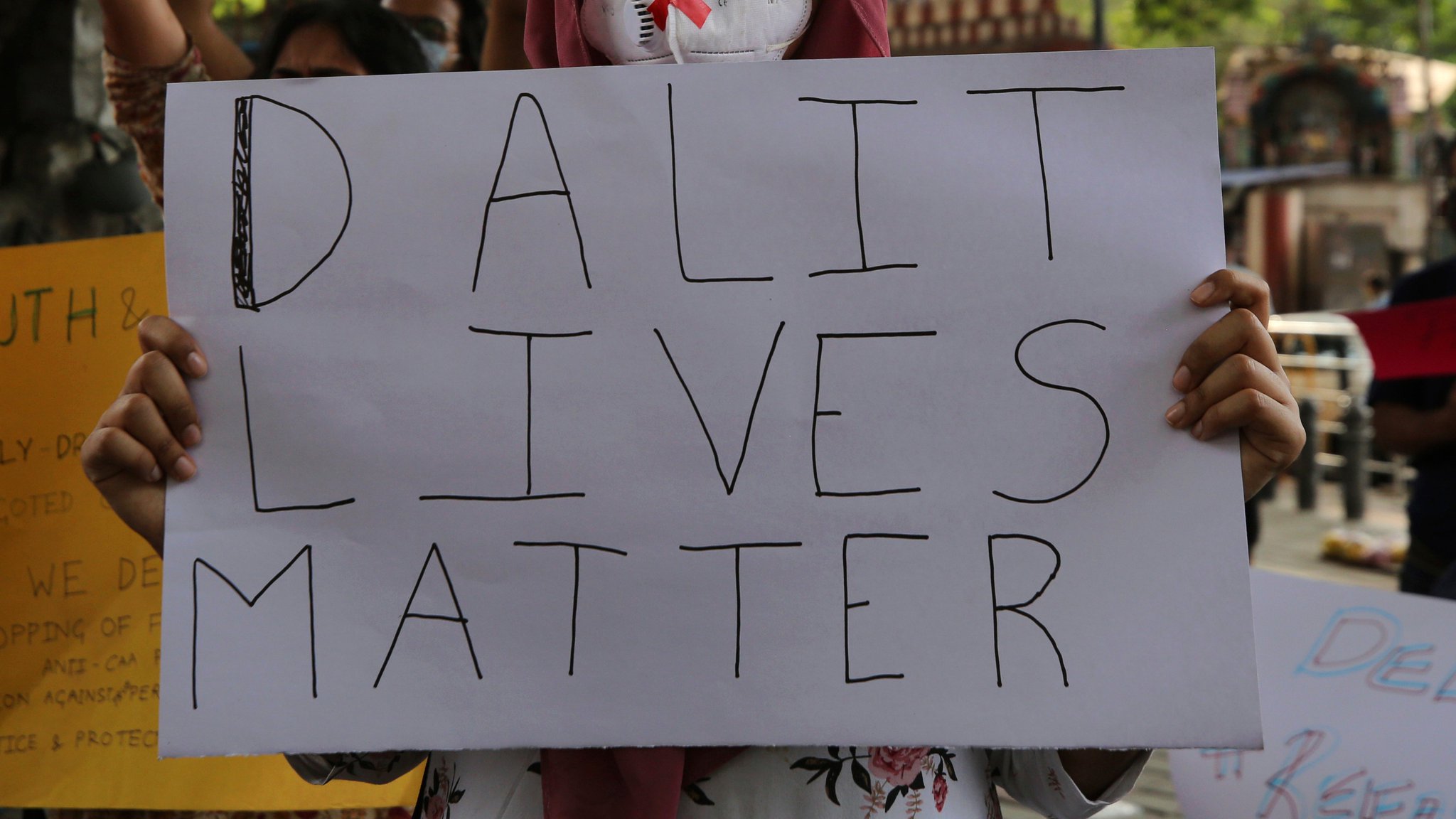 A person holding a placard