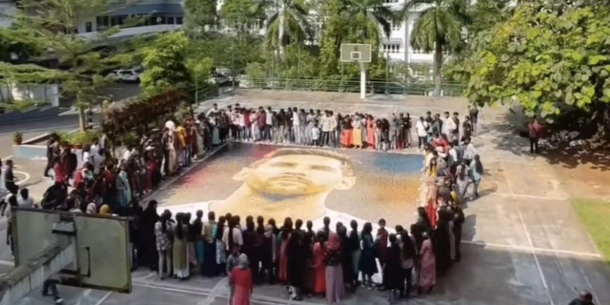Ajay's drawing of Messi displayed on college basketball court. (Screen Grab)