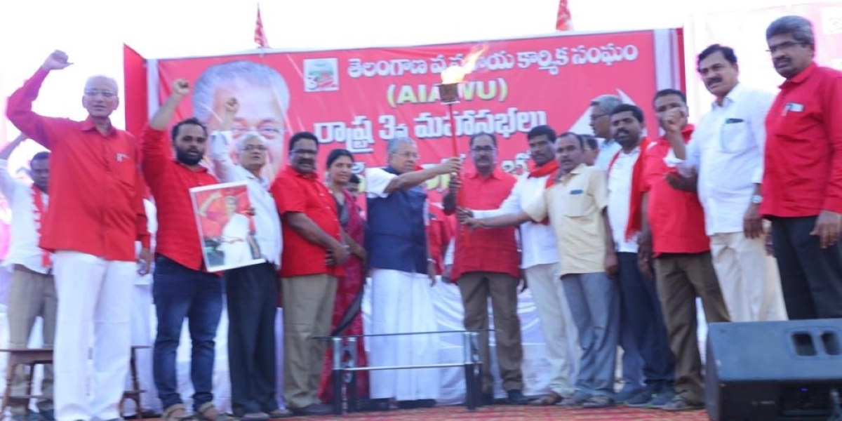 Pinarayi Vijayan holding the lantern at the AIAWU Telangana State Conference (pinarayivijayan/Twitter) Pinarayi Vijayan