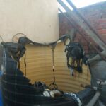 A damaged water tank on the rooftop of a house at Kachi Bowli.