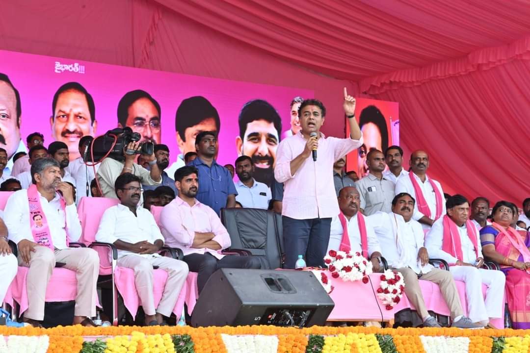 Padi Kaushik Reddy, seated behind KTR in pink shirt, at a public meeting in Huzurabad constituency. (Supplied) Huzurabad Padi Kaushik Reddy BRS