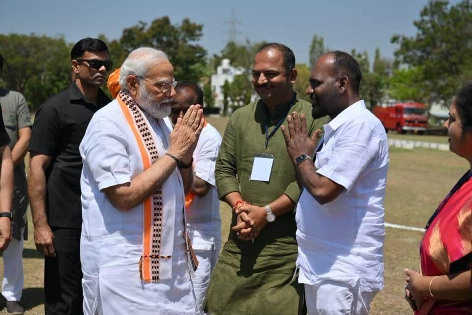 WhatsApp Image 2023-03-12 at 7.30.08 PM PM Modi and 'Fighter' Ravi greeting each other at a helipad in Mandya