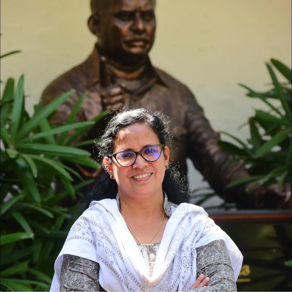 Vadakara MLA and RMP leader KK Rema standing next to a statue of her late husband and RMP leader TP Chandrasekharan. (Supplied)
