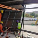 Workers installing steel plates at the Telangana Martyr's memorial