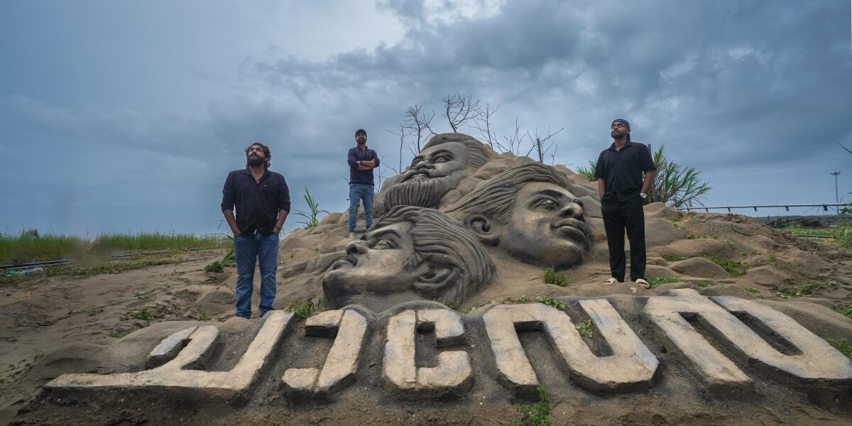 Chaaver actors in front of sand replica Chaaver actors in front of sand replica