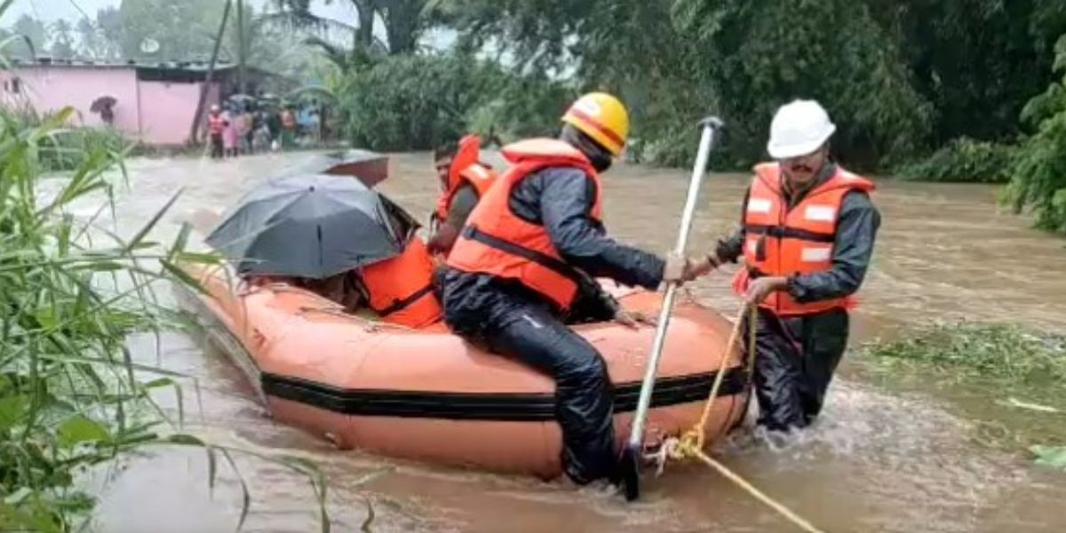 Emergency department personnel rescuing rain affected villagers. Karnataka rains