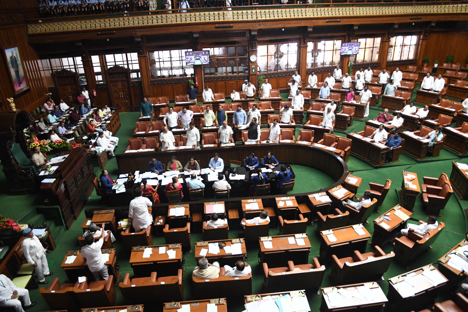 assembly house BJP MLAs staged protests inside the Legislative Assembly against the ruling government for delaying in implementing the five guarantees. (Supplied)