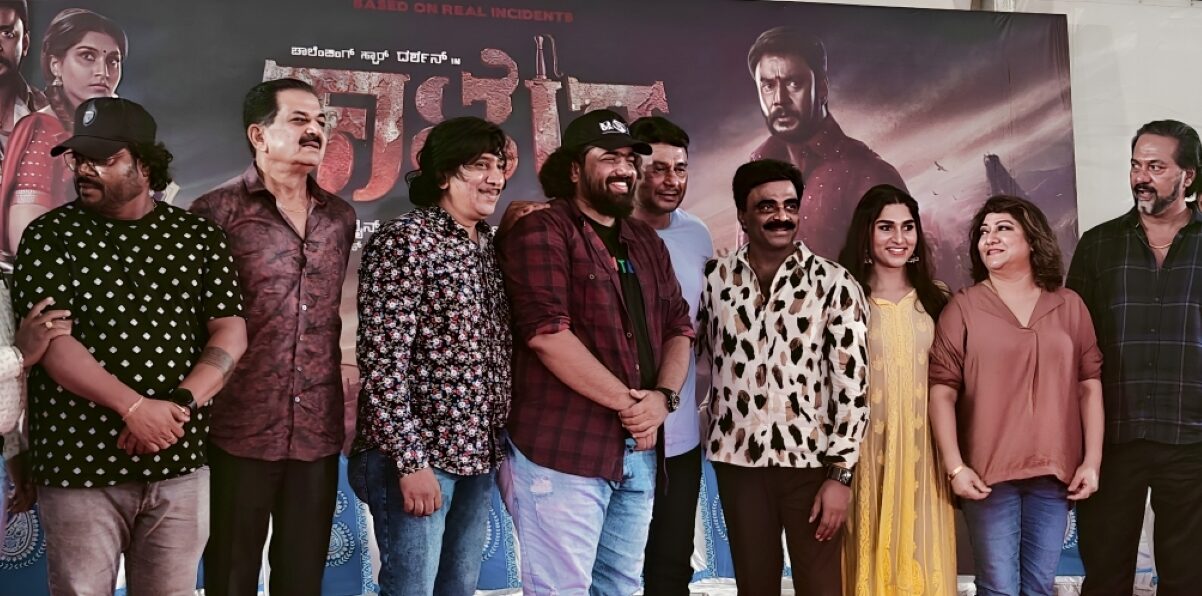 Darshan interacting with the media at a press event for his film Kaatera