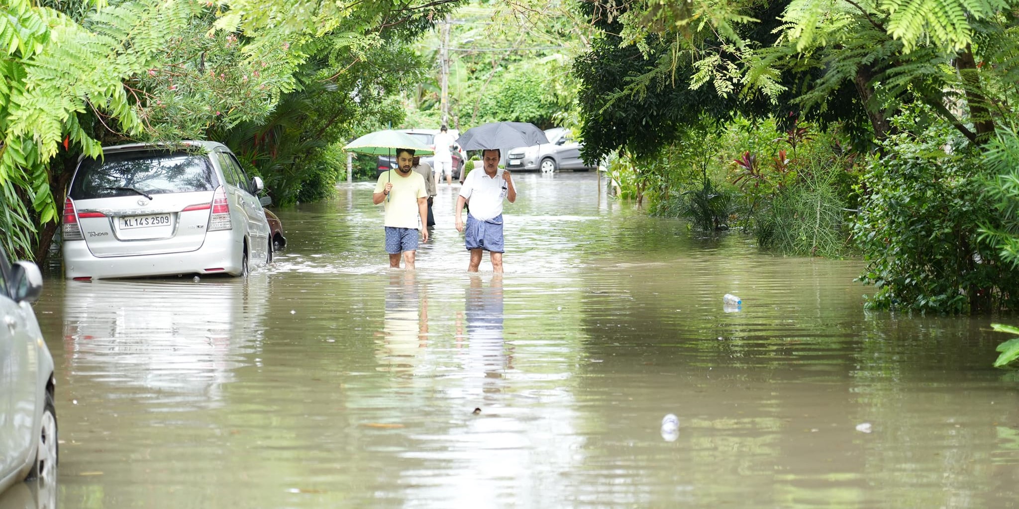 People wading through a watelogged road in Thirunvananthapuram. (Facebook) Thiruvananthapuram flooding